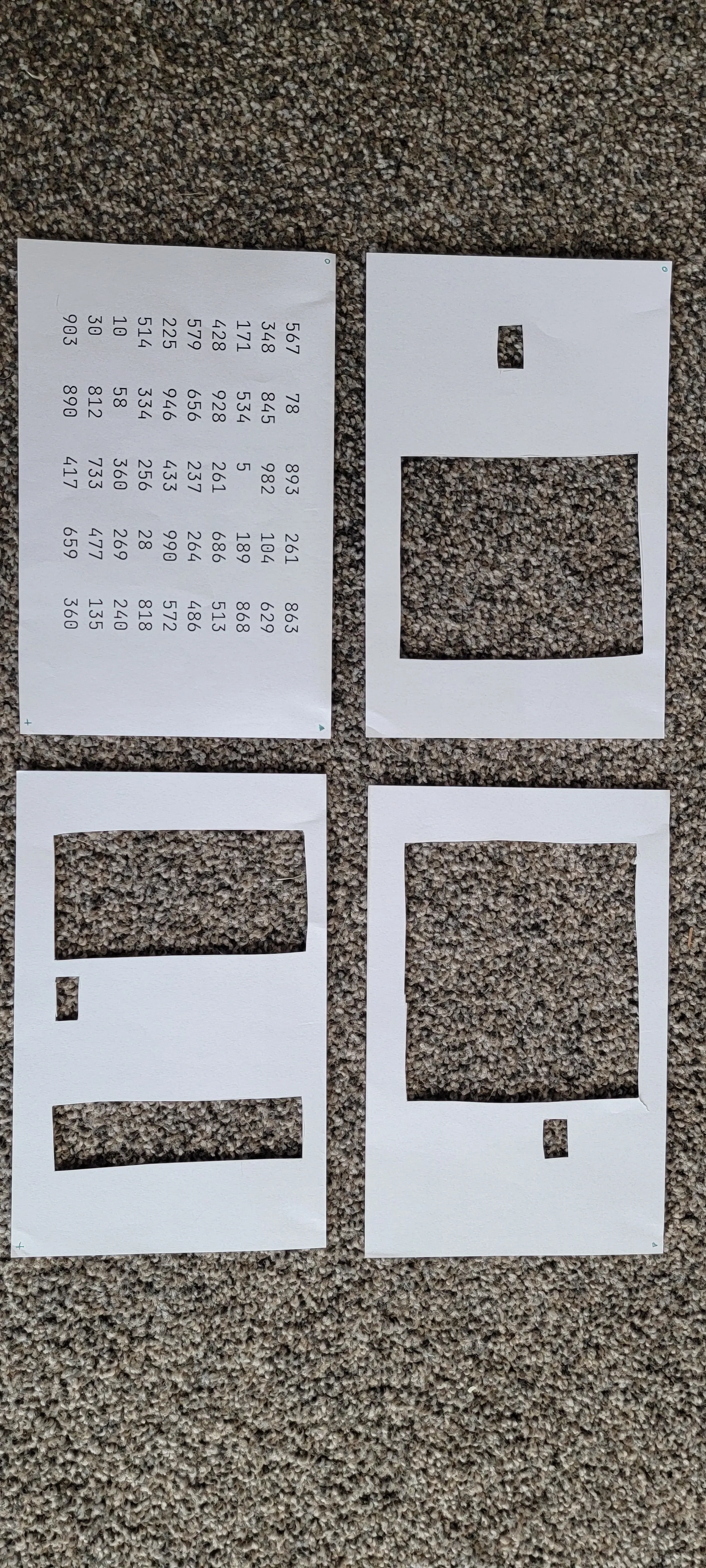 four pieces of paper: one with array of numbers and three pieces of paper with parts cut out
